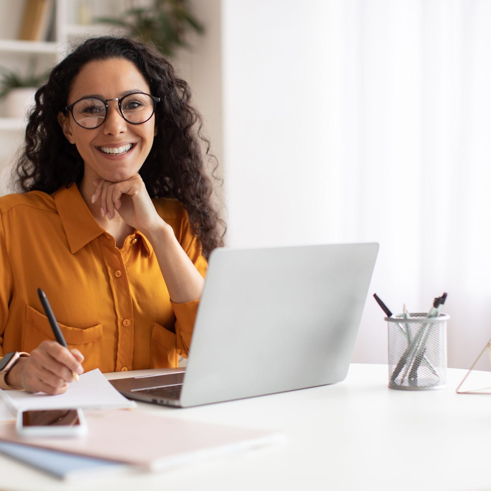 Happy,Brunette,Business,Lady,Using,Laptop,Smiling,To,Camera,Posing ICF membership benefits for individual coaching professionals.