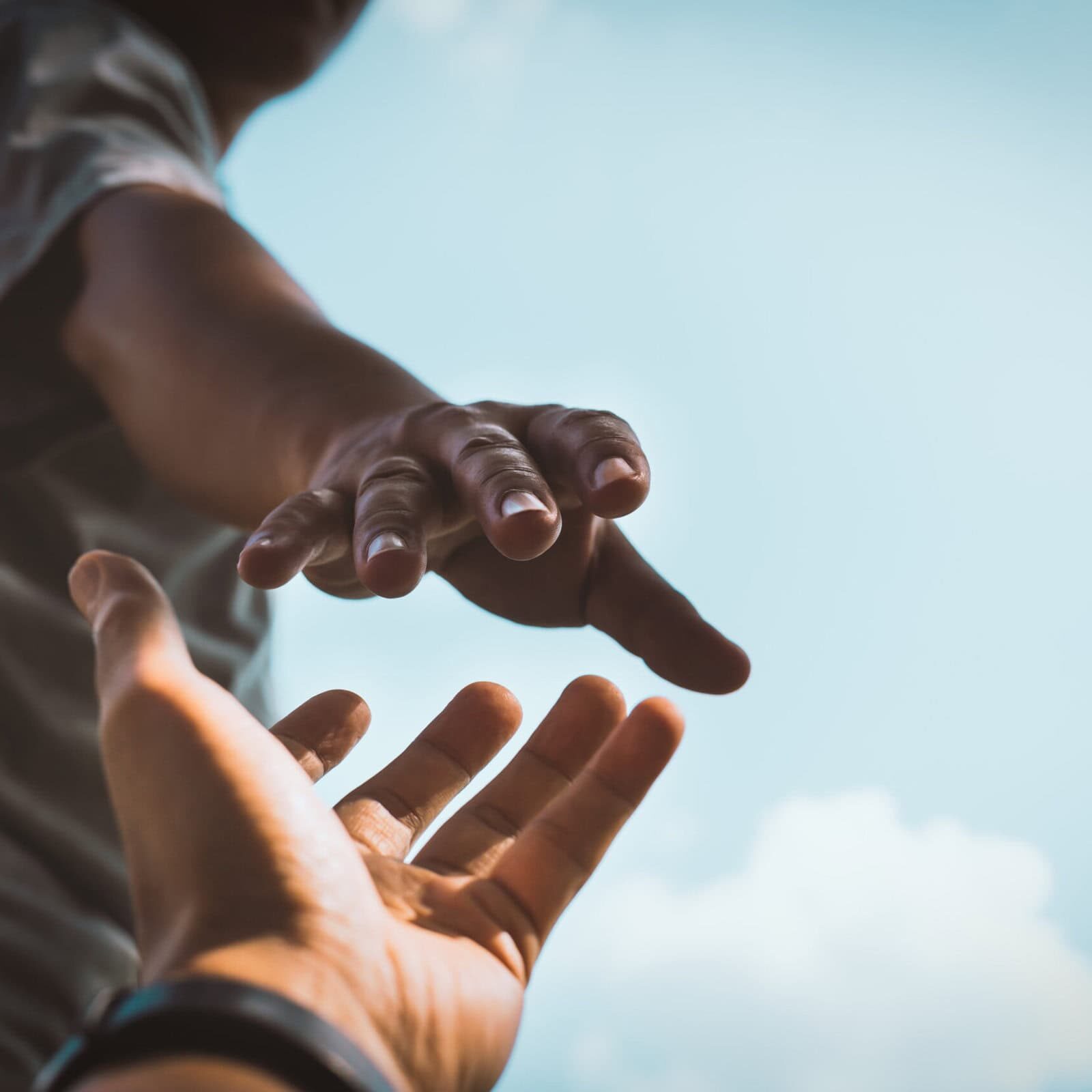 Help Concept hands reaching out to help each other in dark tone. ICF values supporting the global coaching profession