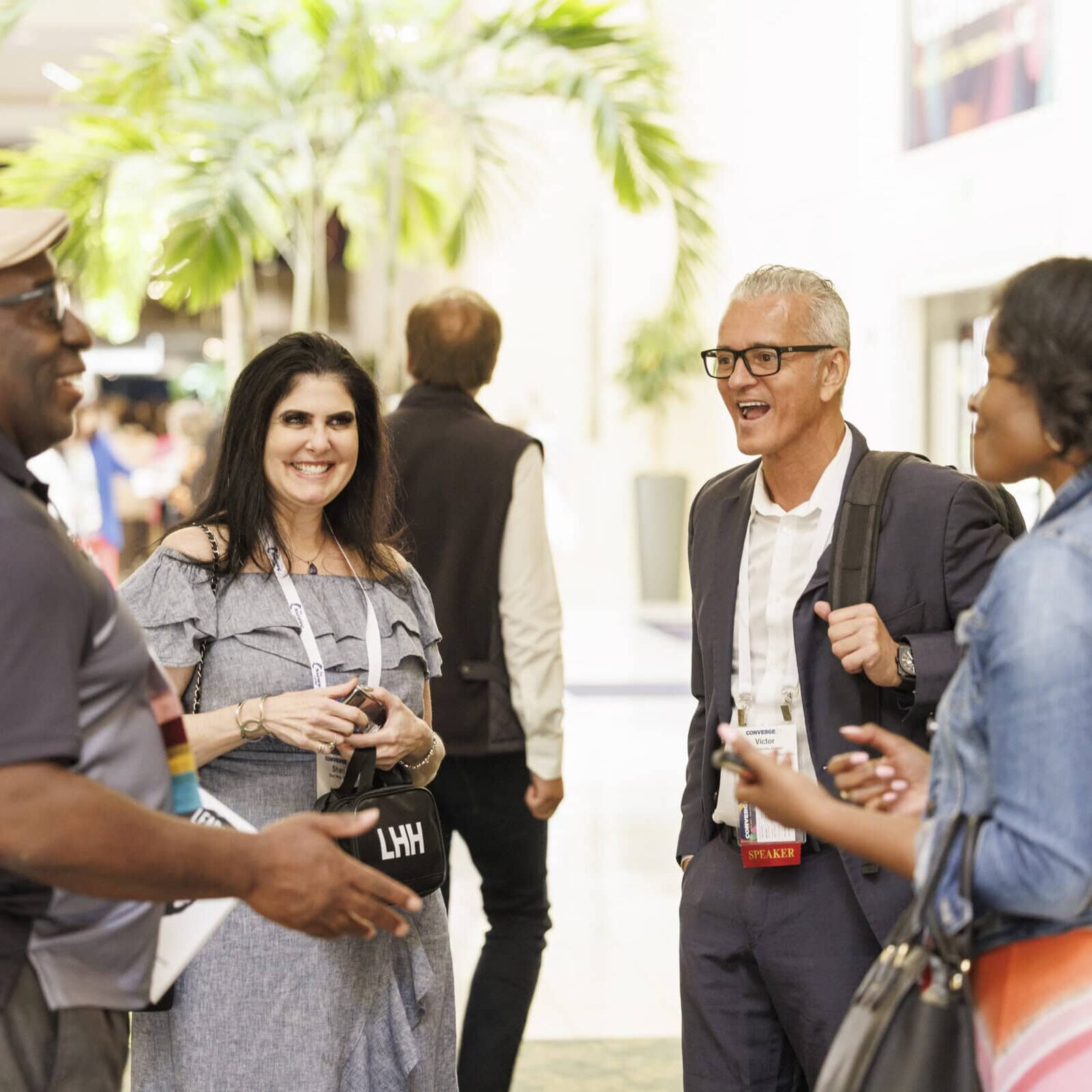 icf-event-attendees-sharing-feedback ICF Converge attendees mingling at the Welcome Reception to kick off the conference.
