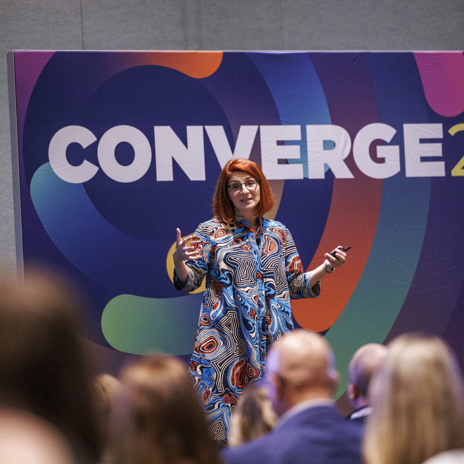 icf-event-speaker-in-action A professional speaker addressing an audience about leadership coaching at an International Coaching Federation event.