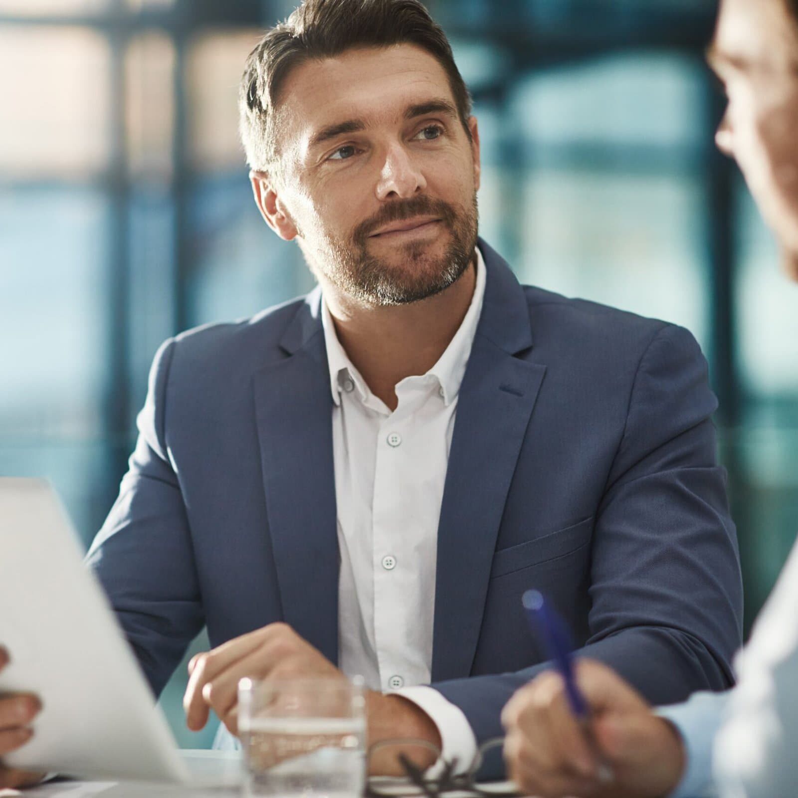 Tablet,,Teamwork,And,Business,People,In,Meeting,In,Office,Workplace. man holding a tablet looking at another who is speaking